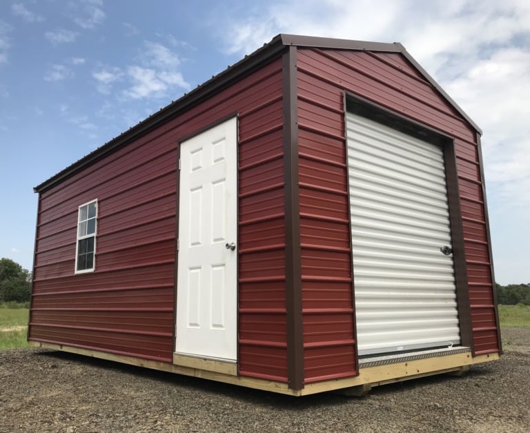 Red Burnett portable garage with a roll-up door